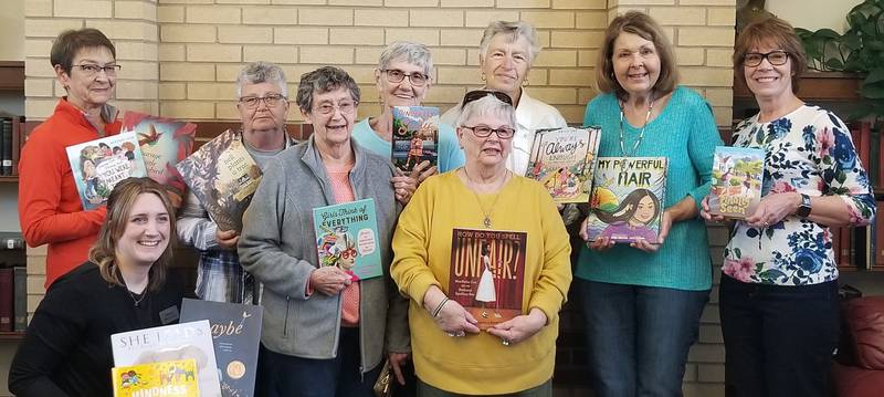 (Front row, from left); Oregon librarian Debbie Herman, Oregon Woman's Club members Valdean Fletcher, Sharon Lung (back row) Maja Shoemaker, Linda Arnold, Sandi Chasm, Christa Young, Johanna Hahne, and Jan Steward.
