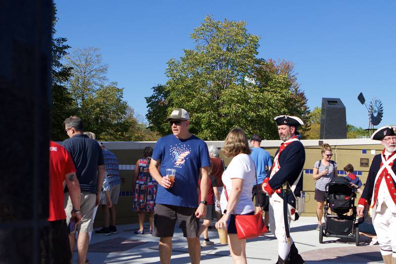 Patriot's enjoy the Flag Day Monument after opening ceremony's at Patriot's Park on Sunday, Oct 1,2023 in Batavia.