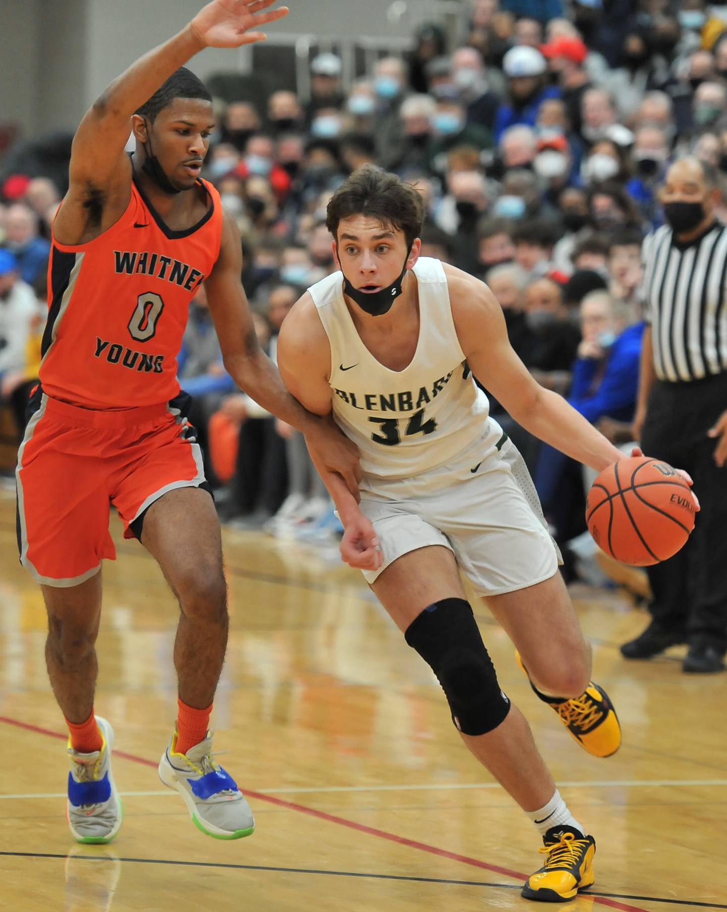 Glenbard West's Braden Huff (34) drives past Whitney Young's A.J. Casey (0) during a game on Jan. 22, 2022 at Benet Academy in Lisle.