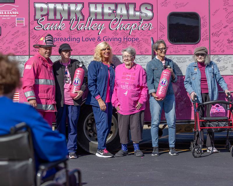 Survivors and current cancer patients pose for photo in front of the Pink Heals Truck on Wednesday, Oct. 8, 2025 at the LaSalle County Nursing Home in Ottawa.