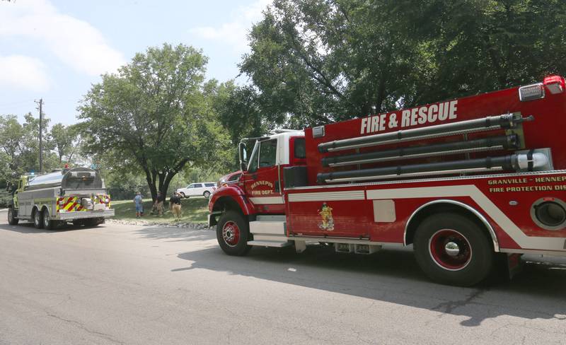 Lacon and Hennepin fire trucks line up along the entrance road at Washington Mills to fight a structure fire Monday, Aug. 18, 2025 near Hennepin. A Mutual Aid Box Alarm System (MABAS) call was placed shortly after 11a.m. Fire departments from La Salle, Bureau and Putnam Counties assisted with the fire.