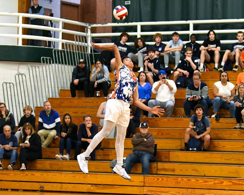 Oak Park River-Forest's Jimmie Chrusfield III (12) serves the ball during the game on Tuesday April 16, 2024, while traveling to take on Glenbard West High School.