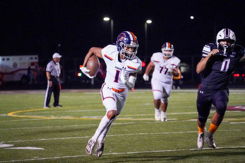 Oswego’s Jeremiah Cain (1) runs after the catch against Plainfield North during a football game at Plainfield North High School on Friday, Sept. 22, 2023.