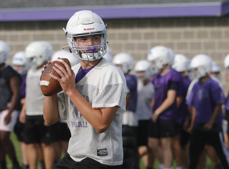 Hampshire’s Luke Lacke drops back to pass during the first day of football practice Monday, August 7, 2023, at Hampshire High School.