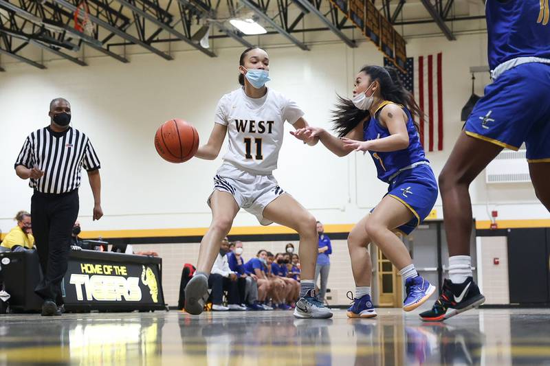 Joliet West’s Caiside Snapp looks for a play against Joliet Central in the Class 4A Moline Regional semifinal. Tuesday, Feb. 15, 2022, in Joliet.