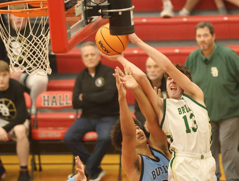 St. Bede's Grahm Ross wiggles in the lane to score over Bureau Valley's Dakarai Martin during the Colmone Classic on Thursday, Dec. 11, 2025 at Hall High School.