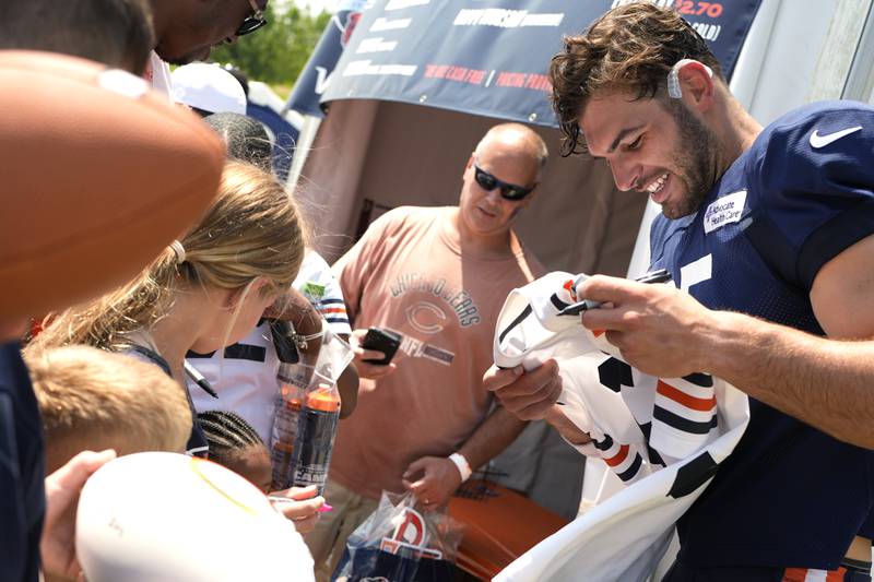 Chicago Bears tight end Cole Kmet signs autographs for fans after an NFL football training camp practice in Lake Forest, Ill., Saturday, July 27, 2024. (AP Photo/Nam Y. Huh)