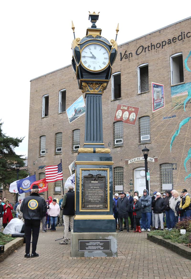A crowd of about 100 people gather around the Soldiers' and Sailors' Memorial Clock to listen to speakers Thursday, Nov. 11, 2021, during a Veterans Day and clock rededication ceremony at Memorial Park in downtown DeKalb.