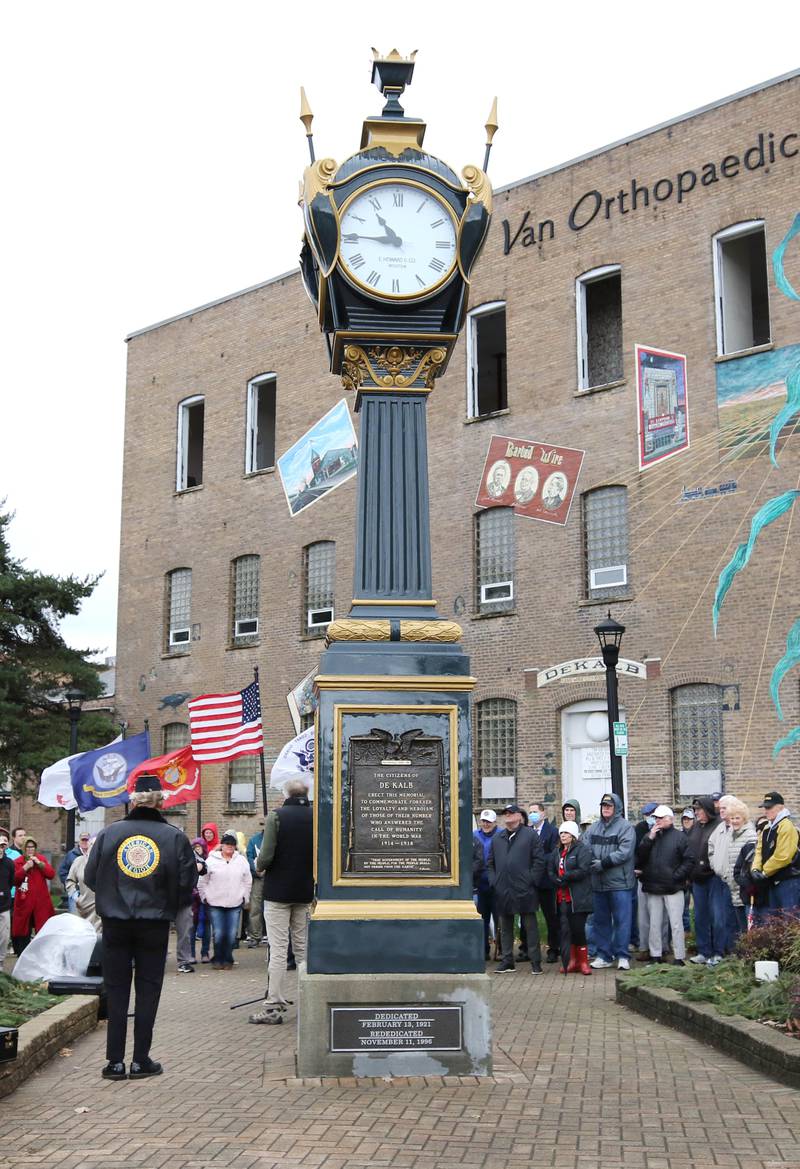 A crowd of about 100 people gather around the Soldiers' and Sailors' Memorial Clock to listen to speakers Thursday, Nov. 11, 2021, during a Veterans Day and clock rededication ceremony at Memorial Park in downtown DeKalb.