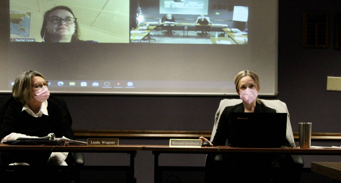 Rachael Gehlbach, at right, vice president of the Dixon Public Schools board of education, takes part in a discussion during a regular meeting on Wednesday, Jan. 20, 2022. Gehlbach gave an update on the Community Engagement Committee's survey on moving the start time of the school day. Board President Linda Wegner appears at left and Rachel Cocar appears by remote video feed in the screen above.