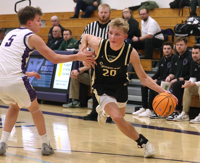 Sycamore's Isaiah Feuerbach drives by Rochelle's Mason Ludwig Friday, Dec. 5, 2025, during their game at Rochelle High School.