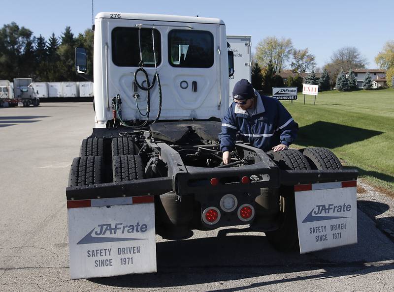 U.S. Army veteran Jordan Wade performs a pre-check before he drives a truck for JA Frate in Crystal Lake. Jordan took part in JA Frate's Green to Gold program that trains drivers to become licensed and more experienced drivers.