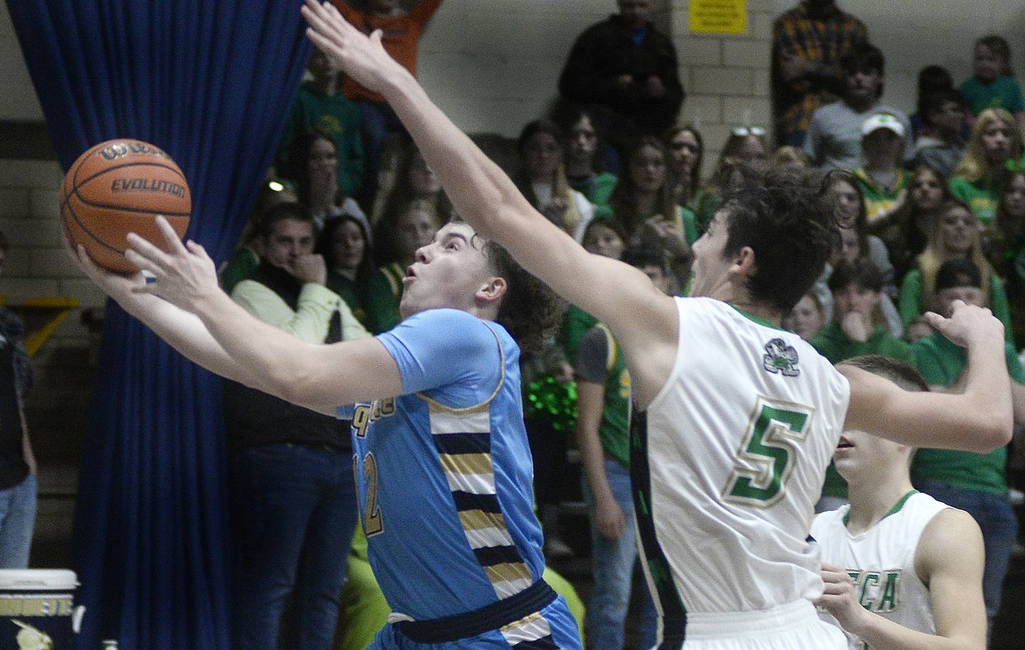 Marquette's Krew Bond drives past Seneca's Kysen Klinker (5) for a shot in Thursday's Marquette Christmas Tournament championship game in Ottawa.