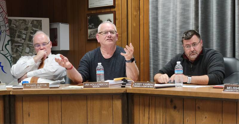 Marseilles Mayor Jim Hollenbeck (center) answers a question at Wednesday's city council meeting while City Attorney Mike Fuller (left) and Commissioner Bobby Kaminski look on.