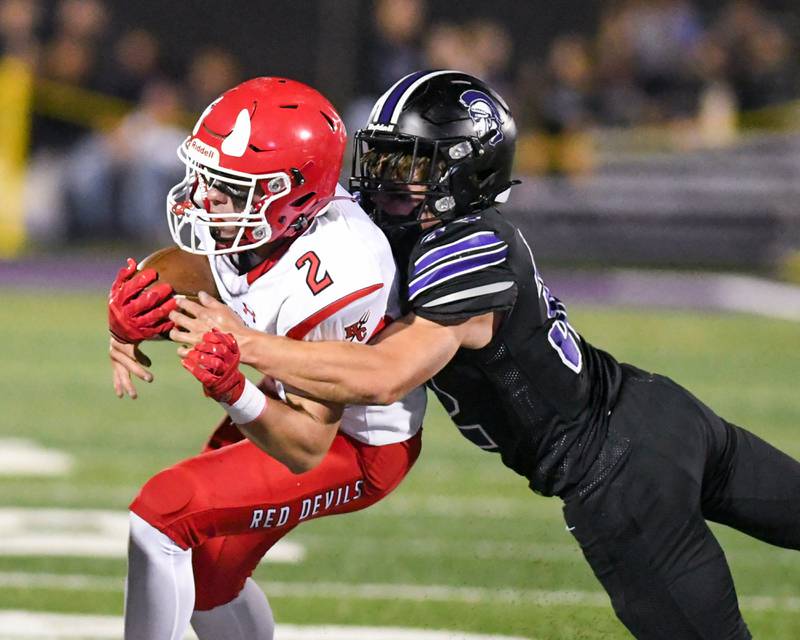 Hinsdale Central's Patrick Connors (2) gains some yards before being brought down by Downers Grove North's Baker Glomb (32) during the game on Friday Sept. 12, 2025, held at Downers Grove North High School.