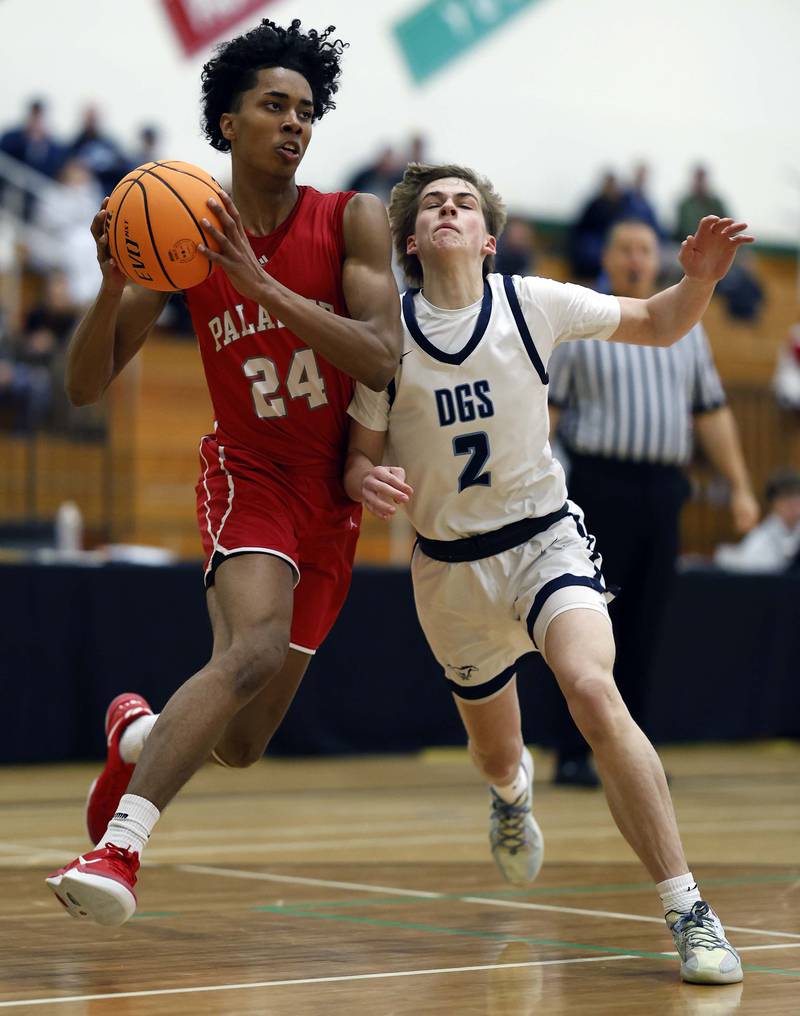 Palatine’s Abram Williams (24) collides with Downers Grove South’s Andrew Waterman (2) during the Jack Tosh Holiday Tournament Thursday, Dec. 26, 2024 at York High School in Elmhurst.