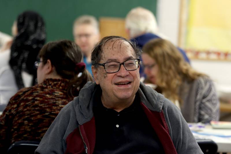 Mark Goldberg of Crystal Lake visits with others during a Chanukah party at The McHenry County Jewish Congregation Sunday.
