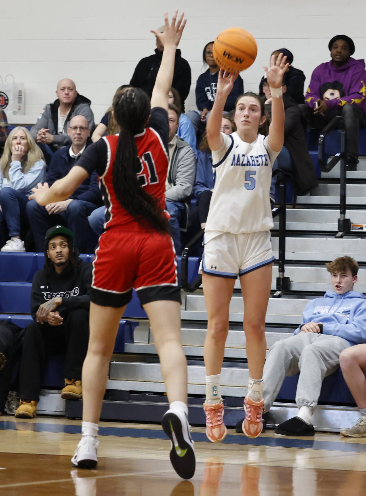 Nazareth's Sophia Towne (5) takes a three-point shot during the girls varsity basketball game between Bolingbrook high school and Nazareth Academy on Monday, Jan. 12, 2026 in La Grange Park.