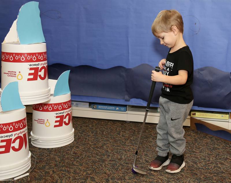 Logan Trousdale tries his hand at mini golf at the Yorkville Public Library Mini Golf FUN Raiser on Sunday, Feb. 2, 2025 in Yorkville.