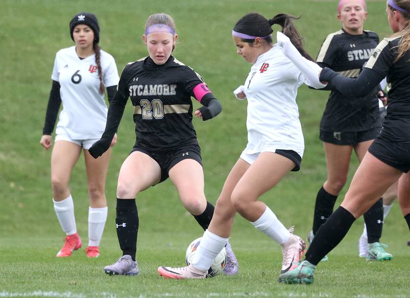 Sycamore's Cortni Kruizenga and La Salle-Peru's Alicia Martin go after the ball during their game Wednesday, April 9, 2025, at Sycamore High School.