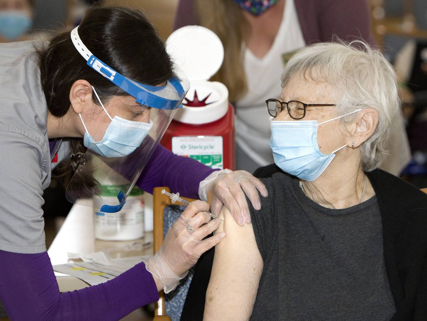 Juliet Vogel a resident of the Timbers of Shorewood, receives the COVID-19 vaccine from Christine Billings, Walgreens pharmacy technician, at Timbers of Shorewood on January 7, 2021, in Shorewood, Ill.