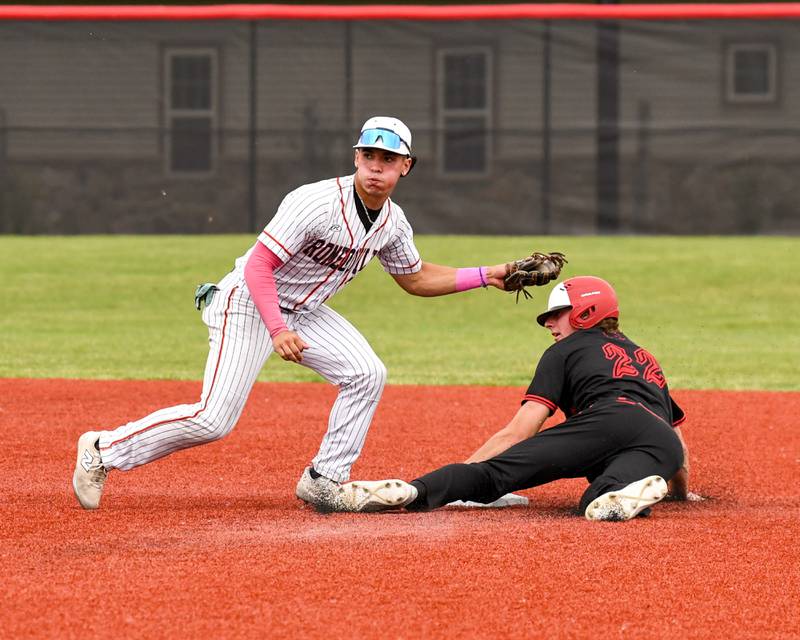 Romeoville's Karlos Otero, left, tries to tag out Yorkville Aaron Klemm (22) as he steels second base as Aaron was called safe during the regional game on Thursday May 29, 2025, held at Yorkville High School.