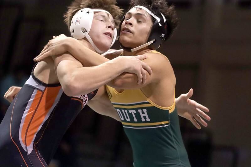 Crystal Lake South’s Erik Gonzalez, right, battles McHenry’s Chris Moore in a 160-pound match during varsity wrestling at Crystal Lake Thursday night.