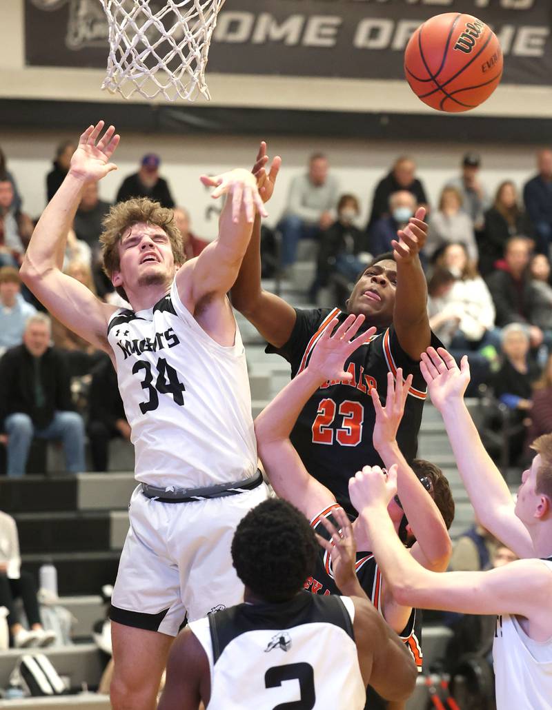 Kaneland's Parker Violett and DeKalb's Davon Grant go after a rebound during their game Tuesday, Jan. 24, 2023, at Kaneland High School.