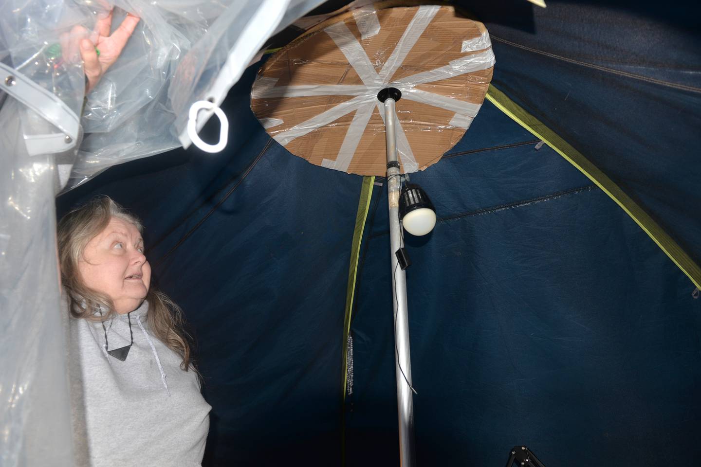 Sarah Wright shows the center pole she created  on Sunday, Jan. 7, 2024 for the center of her tent in preparation of this week's snow storm. Wright has been living in state parks for several months as she searches for a rental property that will accept pets. An Oregon man gave her a van and camping trailer last. month and repairs have started on the 8'x13' trailer, Wright said.