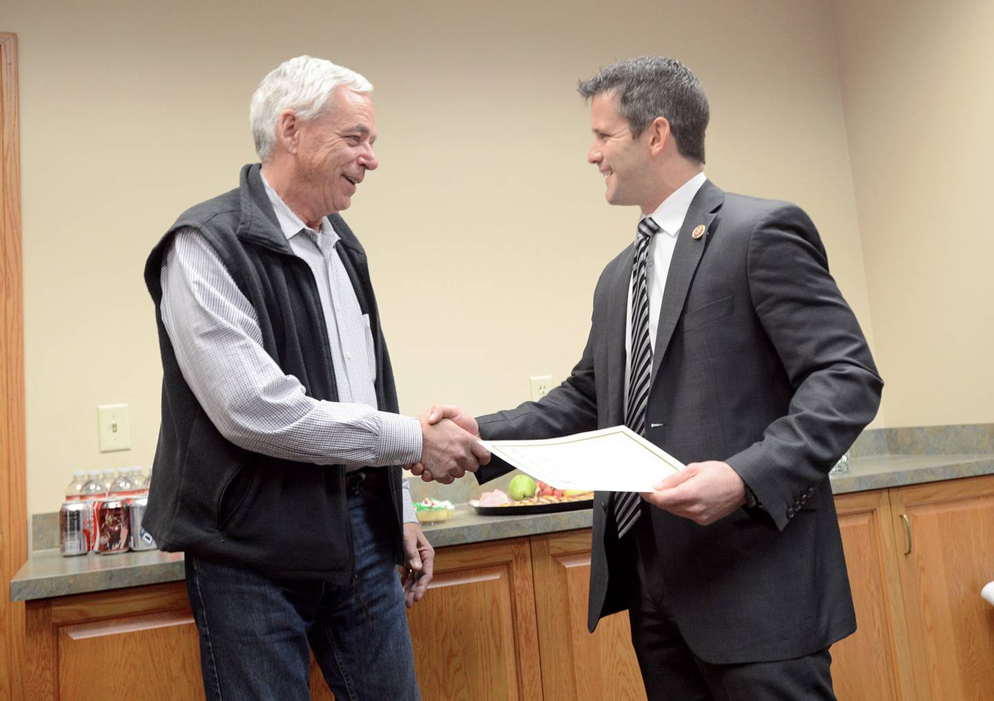 In this file photo, former Ottawa Building Official and Floodplain Manager Mike Sutfin shakes hands with former Congressman Adam Kinzinger, who congratulates him for helping the city obtain a CRS 2 rating, which means Ottawa is among the 10 most prepared cities in the country when it comes to flooding.