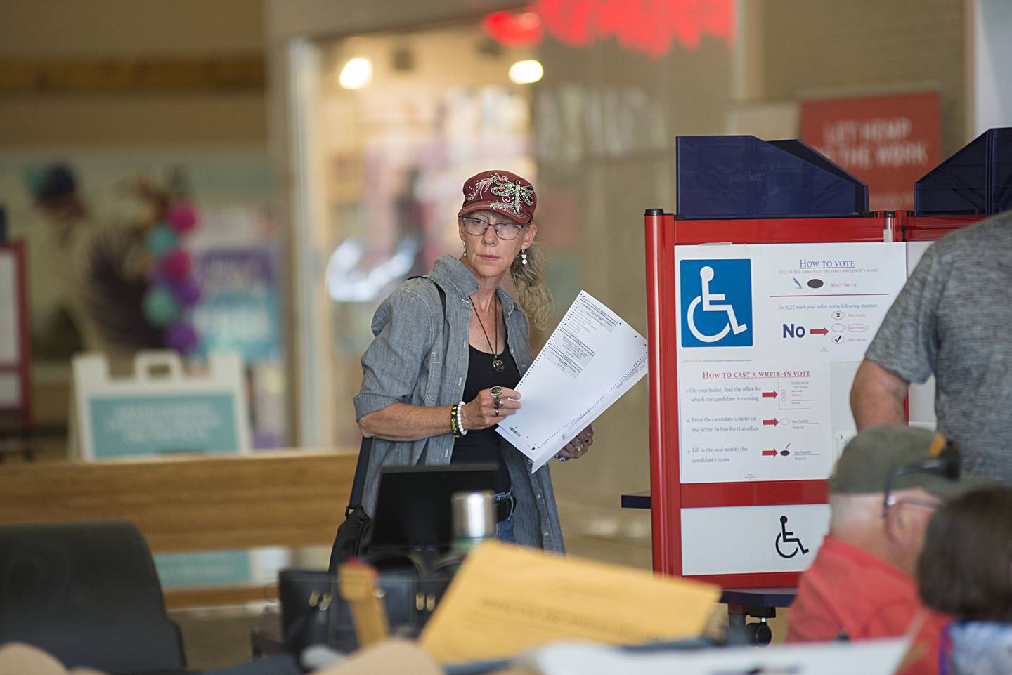 Theresa Hooper-Campos moves to file her ballot after voting Tuesday, June 28, 2022 at the mall in Sterling. The state of Illinois held their primary Tuesday.