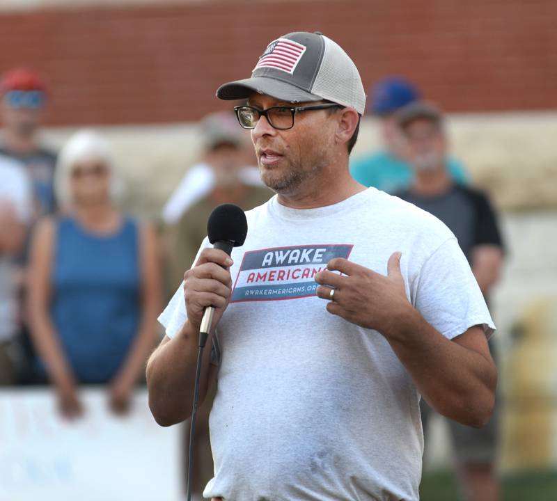 Aaron Mudge of Oregon speaks during a candlelight vigil for Charlie Kirk in downtown Oregon on Sunday, Sept. 14, 2025.