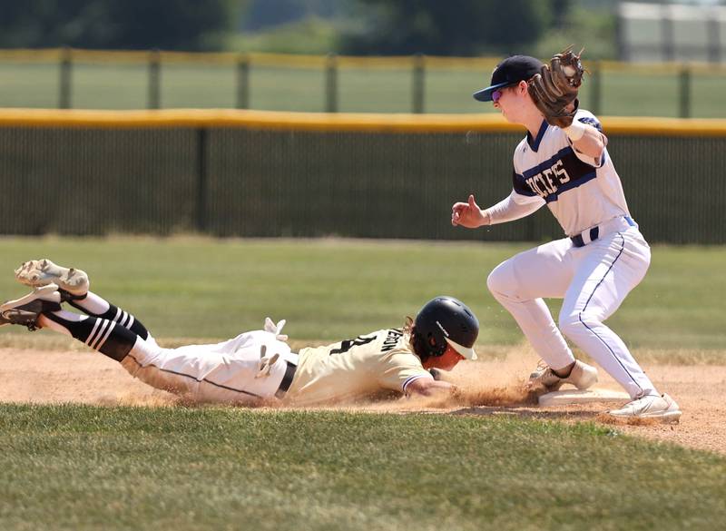 Sycamore's Collin Severson dives back safely on a pickoff attempt as Burlington Central's Brady Gilroy applies the tag during their Class 3A sectional final game against Sycamore Saturday, June 3, 2023, at Kaneland High School in Maple Park.
