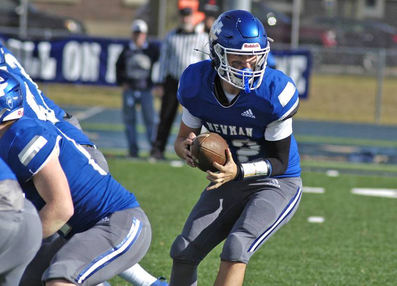Newman Quarterback Evan Bushman prepares to hand off. Newman defeated Chicago Hope 50-22 in Class 1A 1st round football at Sterling High School on Saturday, November 2, 2024.