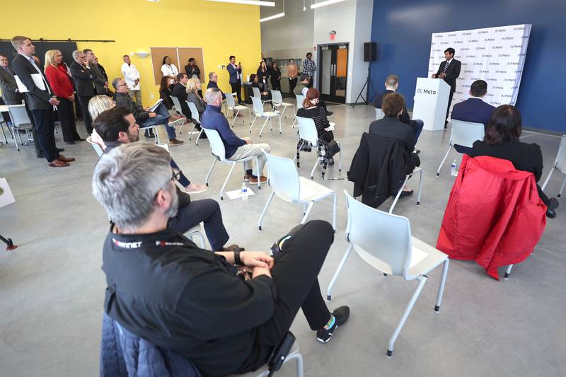 A crowd made up of Meta executives, local officials and media watch during a press conference Wednesday, April 27, 2022, at the Meta DeKalb Data Center. Meta announced Wednesday that they will be expanding the Meta DeKalb Data Center by three new buildings. Once completed, the nearly 2.4 million-square-foot data center will represent an investment of over $1 billion and will support more than 200 operational jobs.