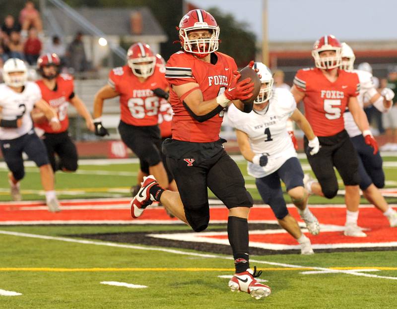 Yorkville running back Josh Gettemy (4) secures a short pass and heads down field against the New Trier defense during a varsity football game at Yorkville High School on Friday, Sep. 1, 2023.