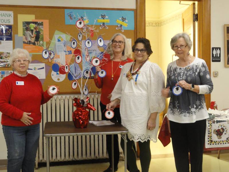 Margaret Carr, Ruth Meinhardt, Dona Jungnickel and Lonnie Schaefer add patriot ornaments to Fort du Rocher's patriot tree.