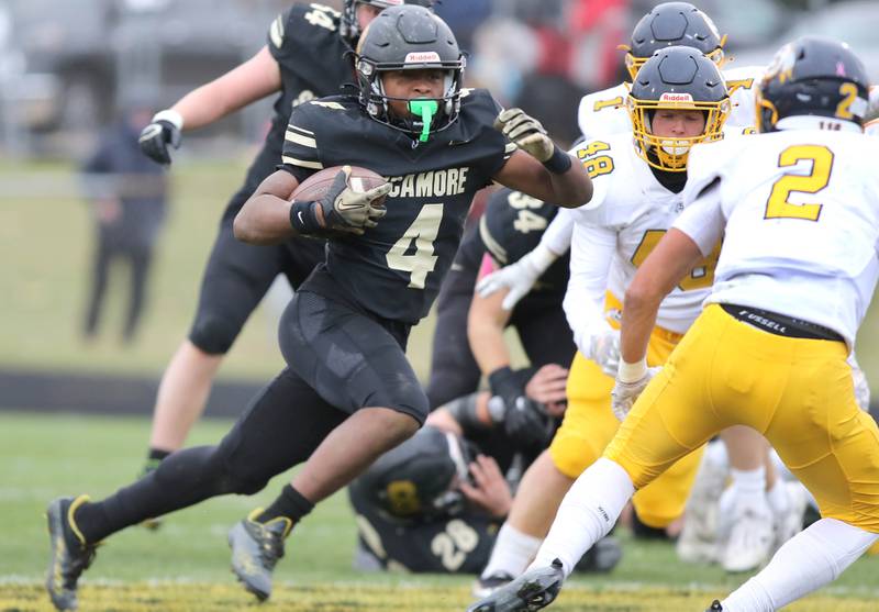 Sycamore's Tyler Curtis looks to get past Sterling's JP Schilling during their Class 5A state playoff game Saturday, Nov. 12, 2022, at Sycamore High School.