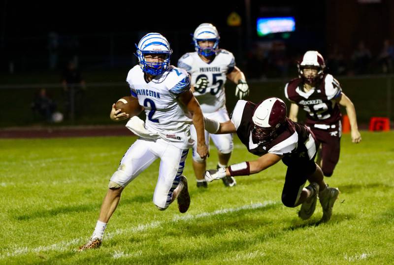 Princeton quarterback Teegan Davis eludes a Rockridge defender Friday night. The Tigers won 41-22.