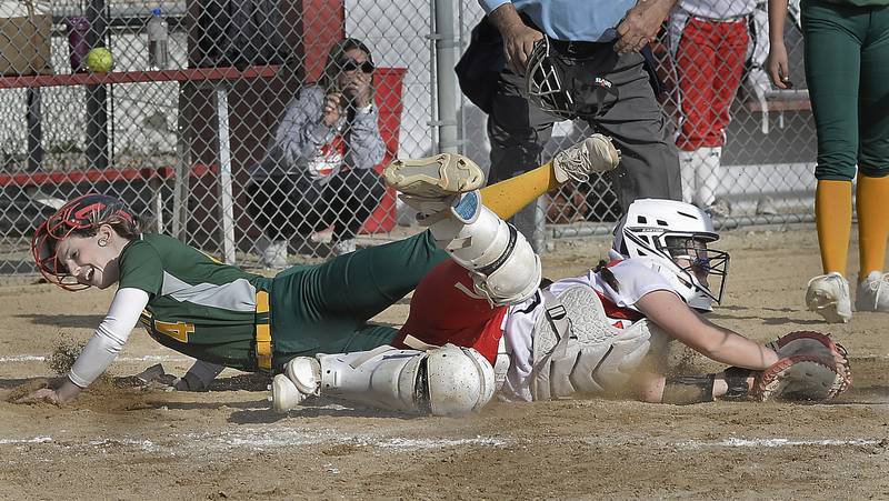 Coal City courtesy runner Addison Harvey scores ahead of the tag from Streator catcher Kadence Ondrey im the third inning Tuesday, April 18, 2023, at Streator.