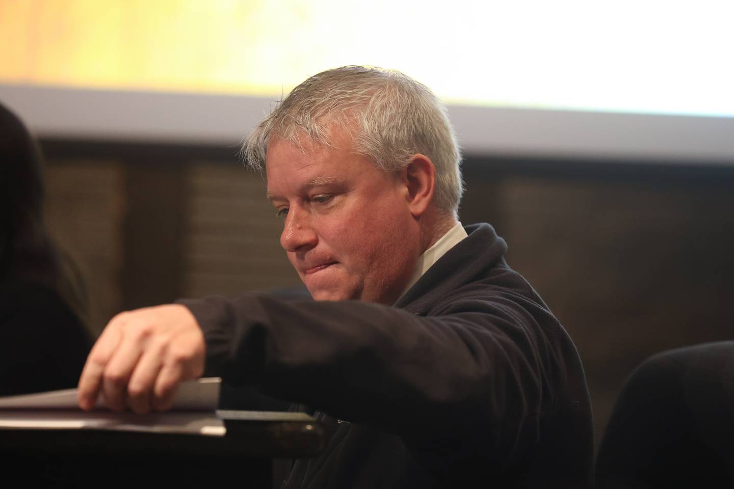Deputy City Attorney Chris Regis goes through documents at a hearing on the validity of nominating petitions of two City Council candidates at the Joliet City Electoral Board meeting on January 4th.