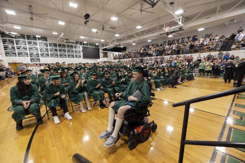 To a thunderous applause, Dylan Wescott crosses the gym after accepting his diploma Sunday, May 18, 2025, at Rock Falls High School. Wescott was injured earlier this year in a track accident.
