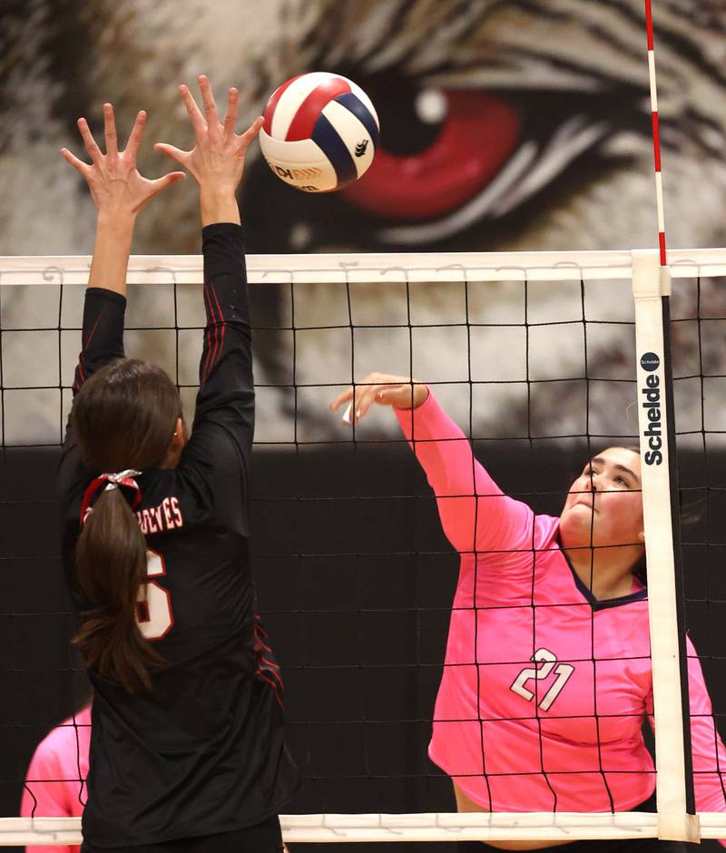 Hiawatha's Mia Siddall spikes the ball into Indian Creek's Isabella Turner during their match Tuesday, Oct. 15, 2024, at Indian Creek High School in Shabbona.