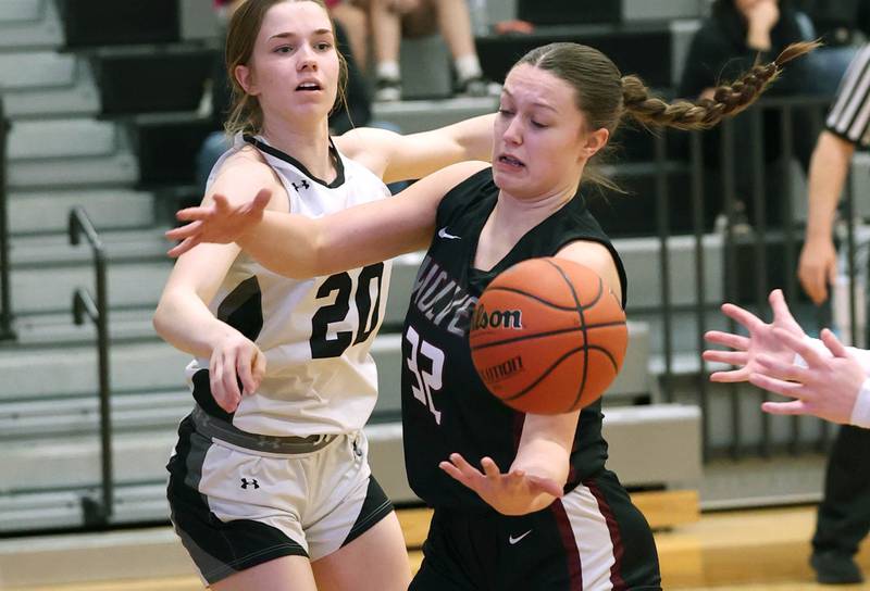 Prairie Ridge's Addison Gertz tries to corral a rebound in front of Kaneland's Sam Kerry Thursday, Feb 15, 2024, during their Class 3A regional final game at Kaneland High School in Maple Park.