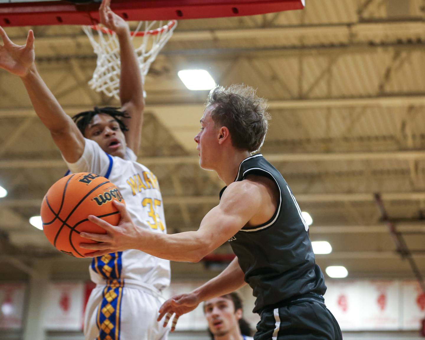 Bolingbrook's Trey Brost (0) passes from underneath the basket during their When Sides Collide Shootout basketball tournament between Warren and Bolingbrook. Jan 25, 2025 in Lisle.