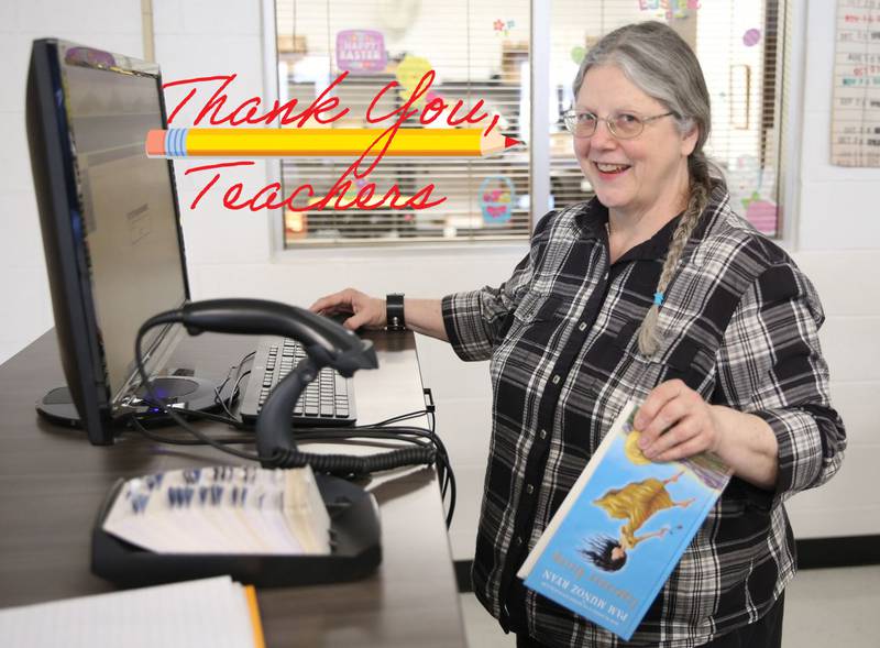 Annette Davis scans a library book on Tuesday, March 28, 2023 at Putnam County High School.