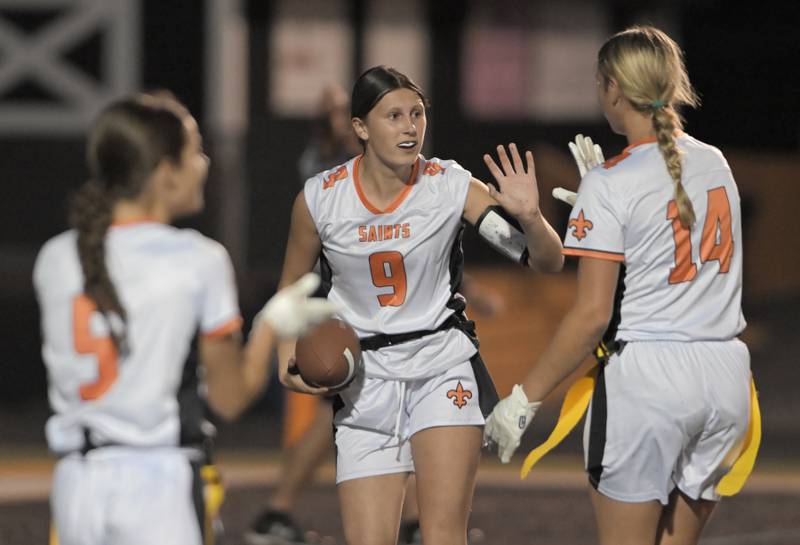 St. Charles East quarterback Ari Bigda celebrates her touchdown run with teammate Brynn Maple in a flag football game in against Wheaton Warrenville South Wheaton on Monday, Sept. 8, 2025.