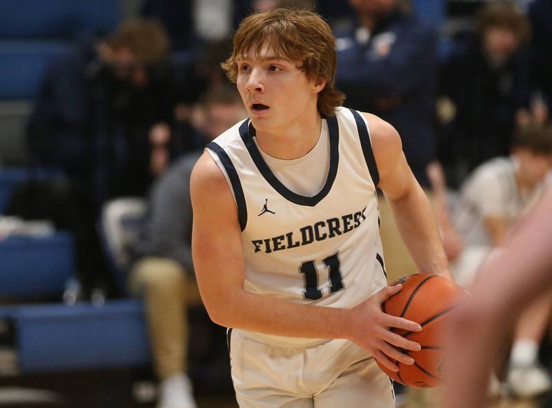 Fieldcrest's Nathan Cook looks to pass the ball off against Fisher on Tuesday, Jan. 2, 2024 at Fieldcrest High School.