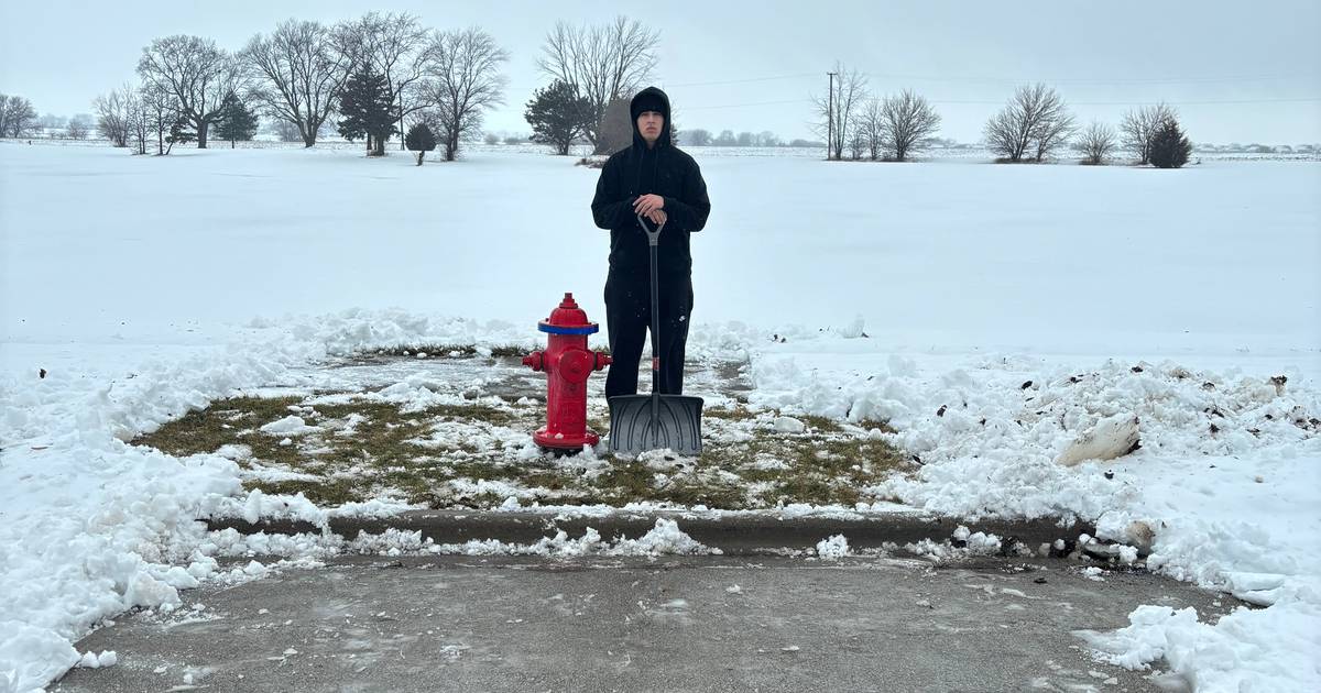 Grundy Area Vocational Center students clear the snow from fire