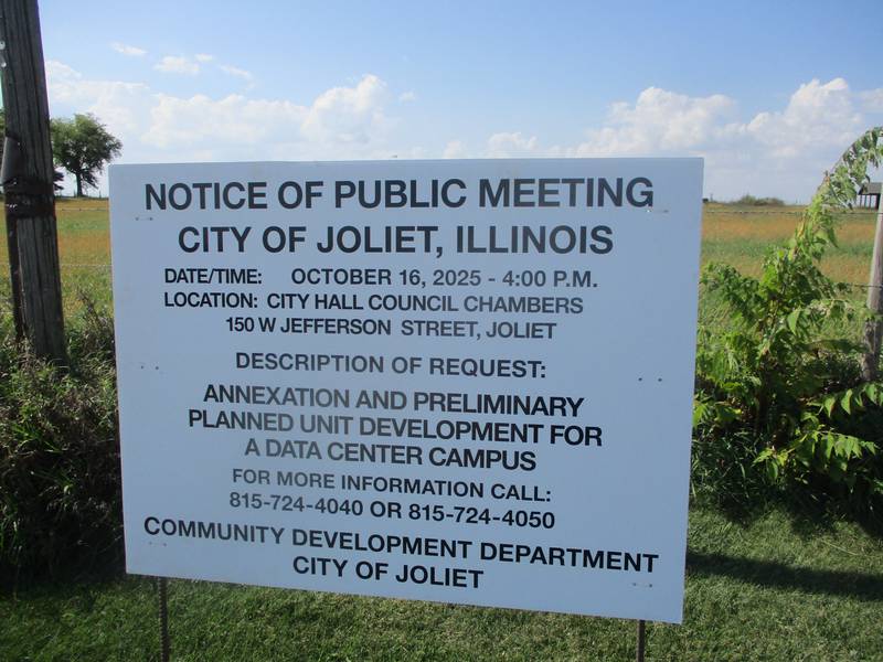 A sign posted on Ridge Road on the edge of a farm field gives notice of a Joliet Plan Commission meeting on a plan to develop the land for a data center. Oct. 3, 2025